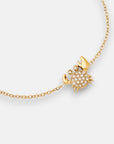 The Princess Goes Hollywood vergoldete Armkette features a small crab pendant with sparkling white gemstones and gold-tone claws and legs, creating a playful yet elegant accessory displayed on a plain white background.