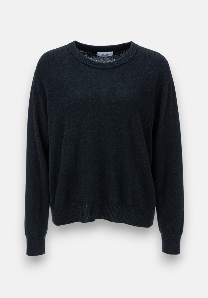 A plain black long-sleeve crewneck sweater by Princess Goes Hollywood is displayed on a light gray background. Crafted from soft knit fabric, it features ribbed cuffs, hem, and neckline for a relaxed fit with no patterns or embellishments.