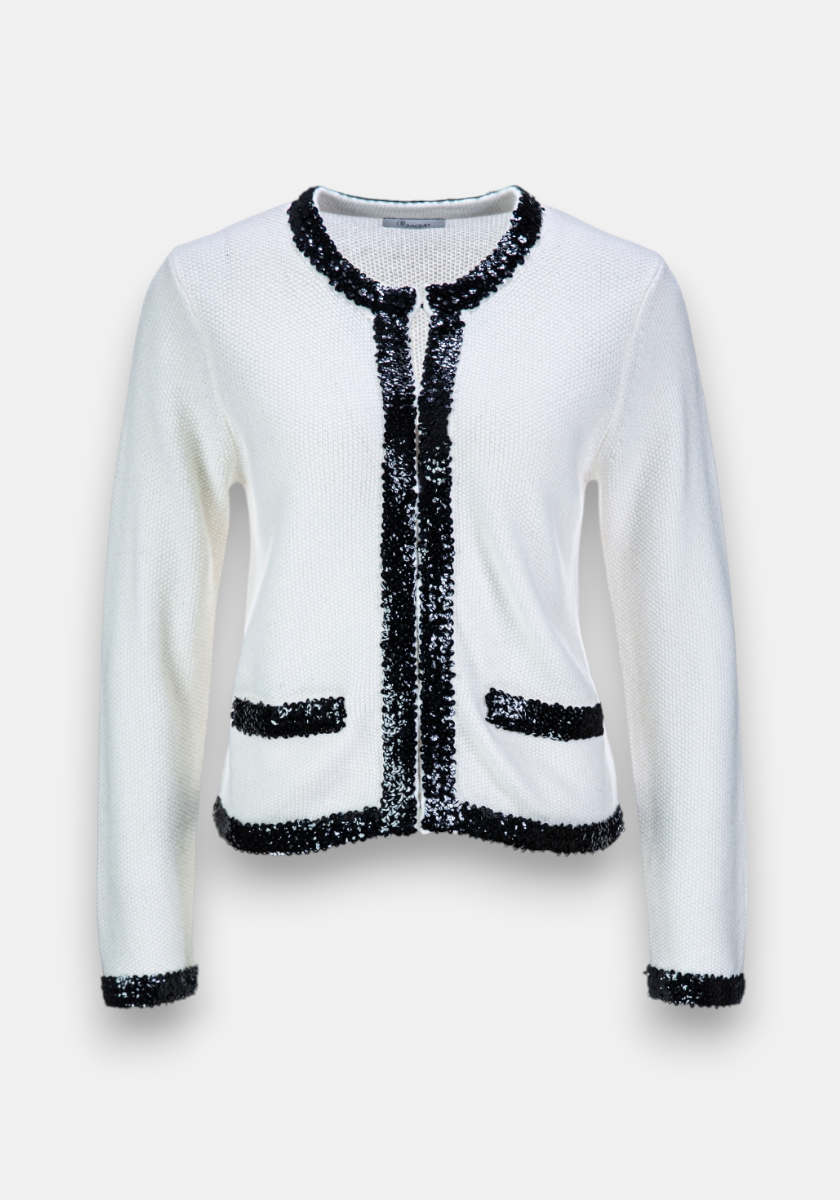 A classic, elegant Strickjacke by Princess Goes Hollywood in white with black sequin trim on the neckline, front opening, cuffs, and two pockets. Contrasting details elevate its luxurious Kaschmir- and Wolle-blend design.