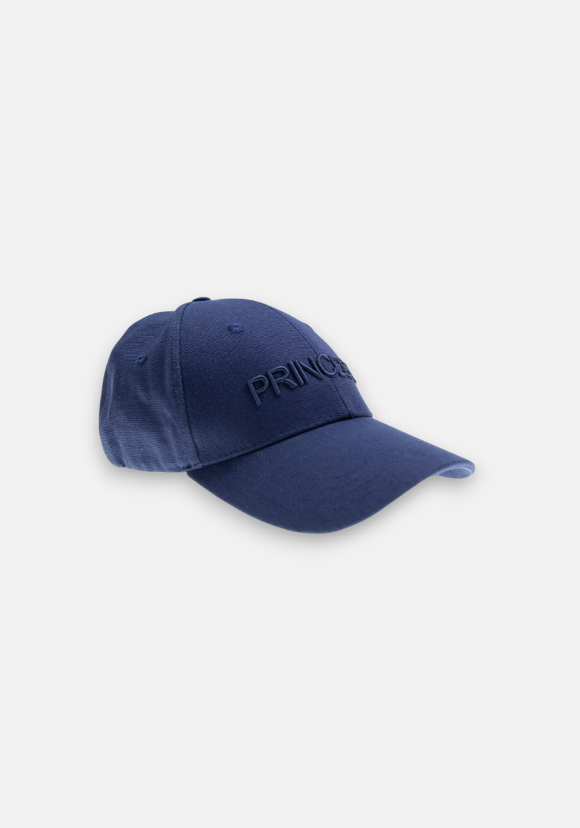 The Blaue Canvas Kappe Princess by Princess Goes Hollywood features PRINCESS embroidery in blue on navy canvas, a chic denim-look, curved brim, and six-panel design. Presented against a light gray background.