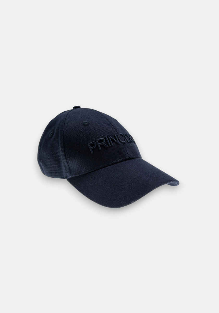 A black denim-look baseball cap by Princess Goes Hollywood with a curved brim, angled view. PRINCESS is subtly embroidered in black on the front. Crafted from Baumwolle with stitched eyelets for ventilation and a top button.