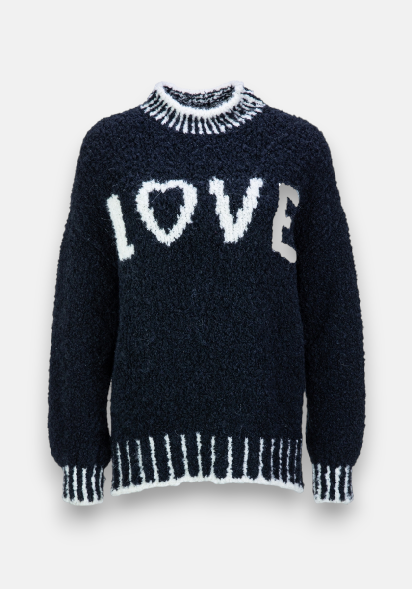 A fuzzy black Grobstrickpullover by Frogbox by Princess with white ribbed cuffs, hem, and collar. LOVE is knitted in white on the chest, the O as a heart. Made from an Alpaka Wolle Mischung. Plain white background.
