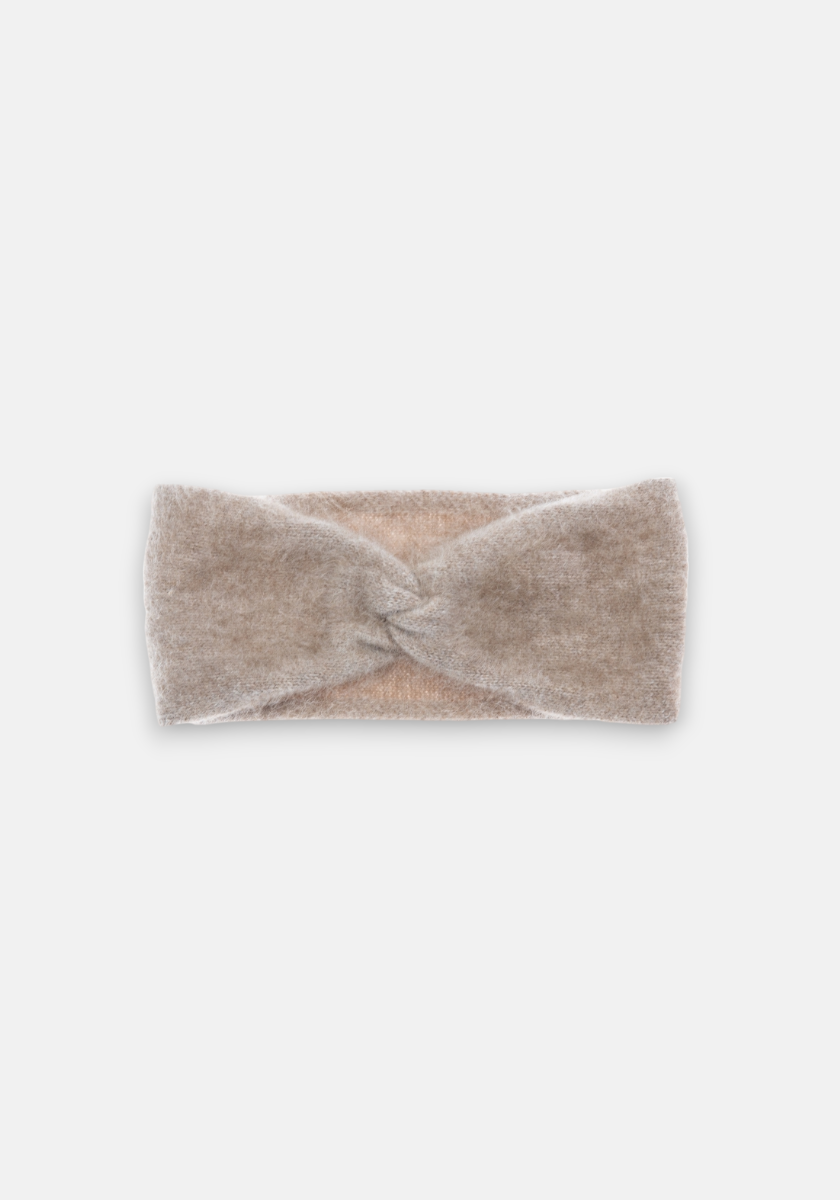 A soft, beige Kaschmir Stirnband by Princess Goes Hollywood is displayed on a plain light gray background. The headband's central Twistdetail adds texture, while its plush fabric suggests warmth and comfort.