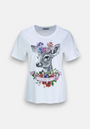 A white T-shirt by Princess Goes Hollywood features a realistic deer motif with colorful flowers, rhinestone accents, a pink HUNTING FOR LOVE banner, purple stars, and a signature on one sleeve.