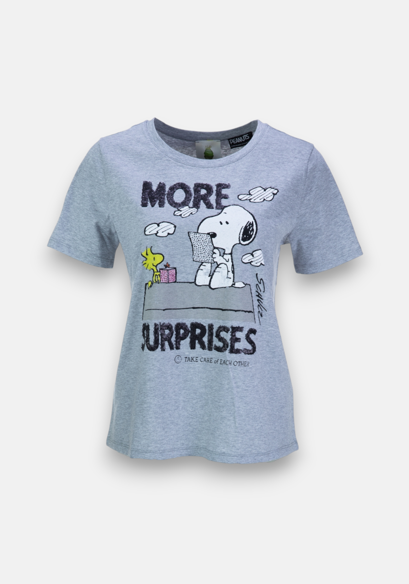 A light gray Princess Goes Hollywood Peanuts-Print T-Shirt in cotton features Snoopy and Woodstock on the doghouse with a pink present, bold "MORE" above, "SURPRISES" below, and "Take care of each other." in small letters underneath.