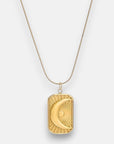 A gold Halskette by Princess Goes Hollywood, crafted from Edelstahl 304, features a rectangular Anhänger engraved with a crescent moon and radiating sunburst, hanging from a thin gold chain against a white background.