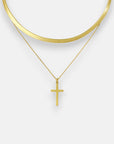 Two gold necklaces by Princess Goes Hollywood: a flat, wide Schlangenkette with a shiny finish, and a thin Halskette Goldoptik with a simple Kreuzanhänger. Both are shown against a plain, light background.