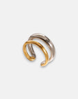 The Princess Goes Hollywood Edelstahl Ring features two intertwined, zweifarbig bands—one shiny silver and one polished gold—curved gracefully to create a minimalist, modern, and elegant design against a plain white background.
