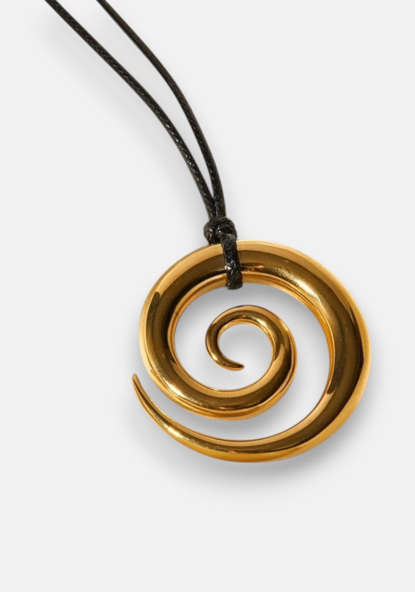 A gold spiral pendant with smooth, glossy 18K Goldbeschichtung by Princess Goes Hollywood hangs from a black cord. The inward-curving, widening spiral shines against a plain white background, highlighting the necklace’s elegant design.