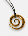 A gold spiral pendant with smooth, glossy 18K Goldbeschichtung by Princess Goes Hollywood hangs from a black cord. The inward-curving, widening spiral shines against a plain white background, highlighting the necklace’s elegant design.