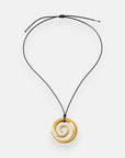 A gold spiral Edelstahl Anhänger with 18K Goldbeschichtung by Princess Goes Hollywood hangs from a simple, adjustable black cord Halskette with gold-tipped ends. The smooth, shiny pendant is set against a plain white background.