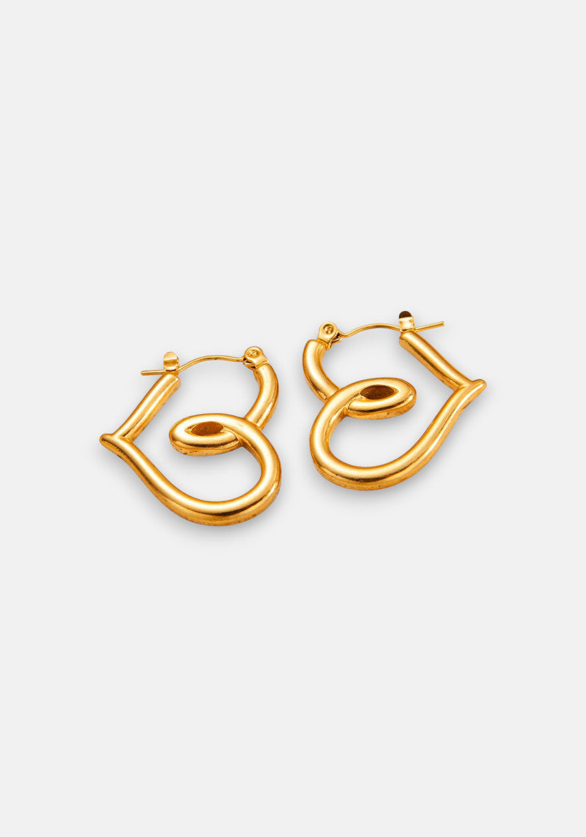 Princess Goes Hollywood presents 18K Gold Creolen hoop earrings shaped into the cursive word Be, with each shiny earring forming a mirrored, looping script displayed on a plain light background.