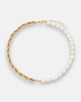 A Princess Goes Hollywood necklace with two halves: one side has a twisted 18K gold-plated chain, the other features irregular freshwater pearls. The circular necklace is shown flat on a plain white background.