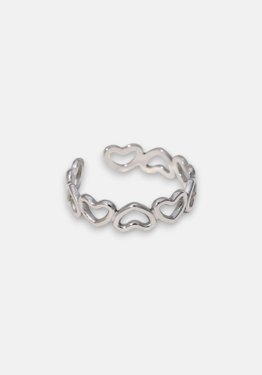 A shiny, adjustable silver ring by Princess Goes Hollywood features a continuous pattern of open hearts and a polished band with an open back, displayed against a simple light gray background.