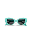 A pair of Okkia cat-eye sunglasses from the Kollektion with thick, glossy, light turquoise blue frames and dark tinted lenses, shown facing forward against a plain white background.