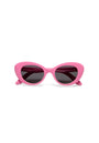 Okkia cat-eye sunglasses from the Kollektion feature bright pink frames, dark tinted lenses, and a bold retro design with thick curved edges and pointed outer tips, displayed front-facing on a white background.