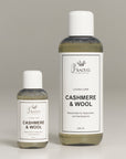 Two bottles of Princess Goes Hollywood Kaschmir & Wolle Pflegewaschmittel stand upright on a light gray surface: the 50 ml bottle is on the left, and the 240 ml bottle is on the right. Both feature white caps and minimalist white labels with black text.