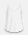 A simple white Bella Dahl Trägertop with thin spaghetti straps and a V-shaped neckline, shown on a plain light gray background. The Lyocell fabric looks smooth, slightly flowing, with a subtle sheen and gentle curves at the hem.