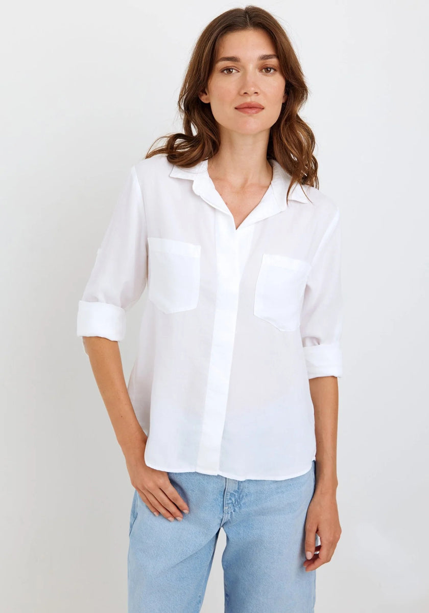 A woman with wavy brown hair wears a sheer white Bella Dahl Lyocell Hemd with rolled sleeves and two chest pockets, paired with light blue jeans. She stands against a plain white background, looking at the camera with a relaxed expression.