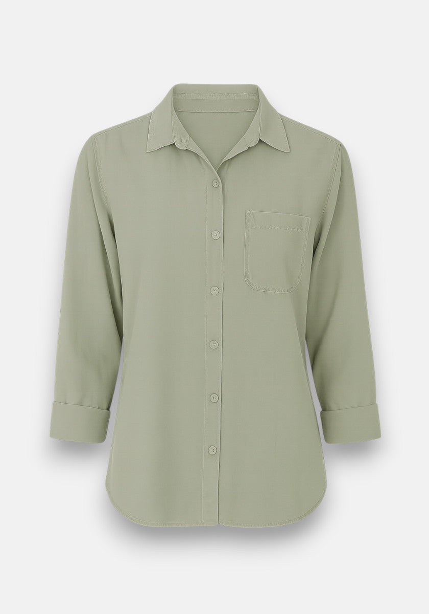 A light sage green Bella Dahl Lyocell Hemdbluse features a classic collar, button placket, long sleeves rolled to three-quarter length, a left chest pocket, and a slightly curved hem, displayed against a plain white background.