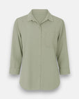 A light sage green Bella Dahl Lyocell Hemdbluse features a classic collar, button placket, long sleeves rolled to three-quarter length, a left chest pocket, and a slightly curved hem, displayed against a plain white background.