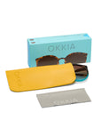 A pair of Okkia Sonnenbrille tortoiseshell sunglasses, partly inside a bright yellow case, come with a light gray cleaning cloth and a turquoise OKKIA box with a window. These retro shades offer stylish UV 400 eye protection.