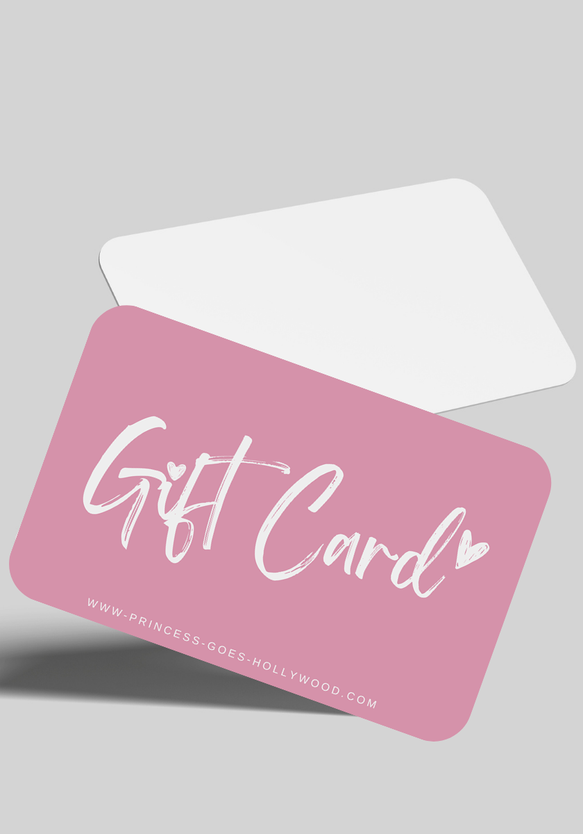 A pink Princess Goes Hollywood gift card with white, playful Gift Card script and a small heart, tilted above a white envelope on light gray. Includes the website www.princess-goes-hollywood.com—perfect for fashion lovers.