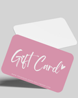 A pink Princess Goes Hollywood gift card with white, playful Gift Card script and a small heart, tilted above a white envelope on light gray. Includes the website www.princess-goes-hollywood.com—perfect for fashion lovers.