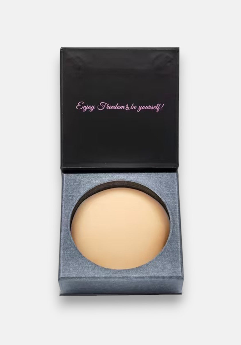 A round beige Silikon powder compact from Princess Goes Hollywood sits in an open black box. The inside lid says Enjoy Freedom & be yourself! in pink and white cursive, set on a gray insert with a light gray background.
