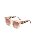 Okkia cat-eye sunglasses feature blush pink translucent frames, gradient brown lenses, and retro tortoiseshell arms. Offering UV 400 protection for your eyes, these stylish shades are set against a white background.