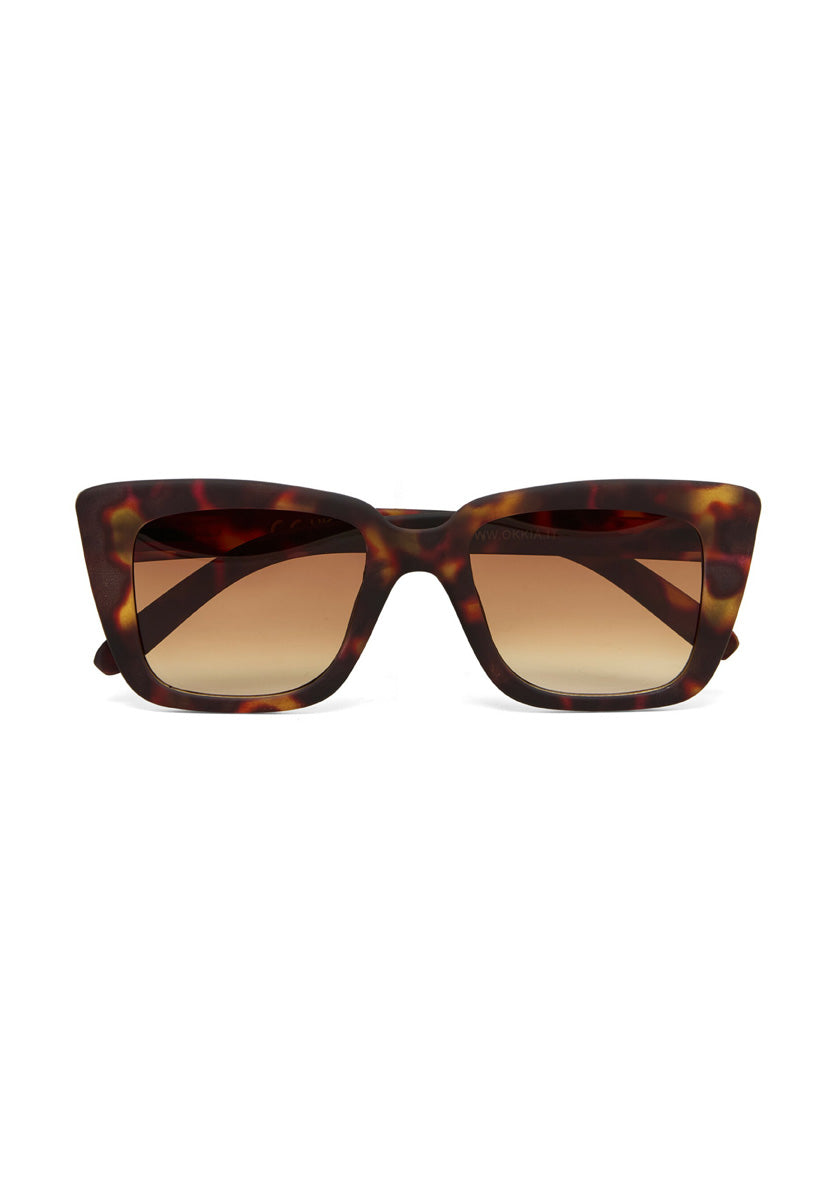 Okkia rectangular cat-eye sunglasses with a brown tortoiseshell pattern and gradient brown lenses, showcased on a white background. The bold frame has pointed corners and thick arms, giving a modern, stylish appeal.