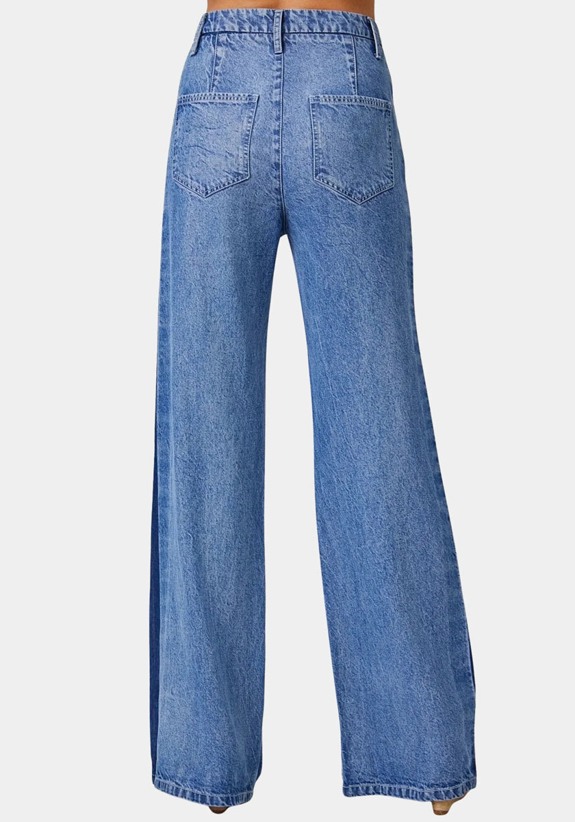 A person wearing Bella Dahl high-waisted, light blue wide-leg jeans is shown from the back. The jeans feature two large back pockets, a slightly faded wash, and loose straight legs that cover the shoes against a plain white background.