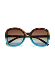 Okkia oversized sunglasses with rounded frames feature a brown tortoiseshell upper half and gradient blue lower half. Brown tinted lenses fade lighter at the bottom. Displayed against a white background.