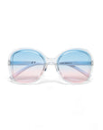 Large, round Okkia sunglasses with transparent frames in a chic butterfly style. Blue-to-pink gradient lenses offer UV protection. www.okkia.it is printed on the right lens. Set against a plain white background.