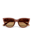 Front view of Okkia brown Cat-Eye sunglasses with wide, angular frames, dark brown gradient lenses, and a soft-touch finish. Slightly curved arms and full UV protection provide comfort and eye safety against a white background.