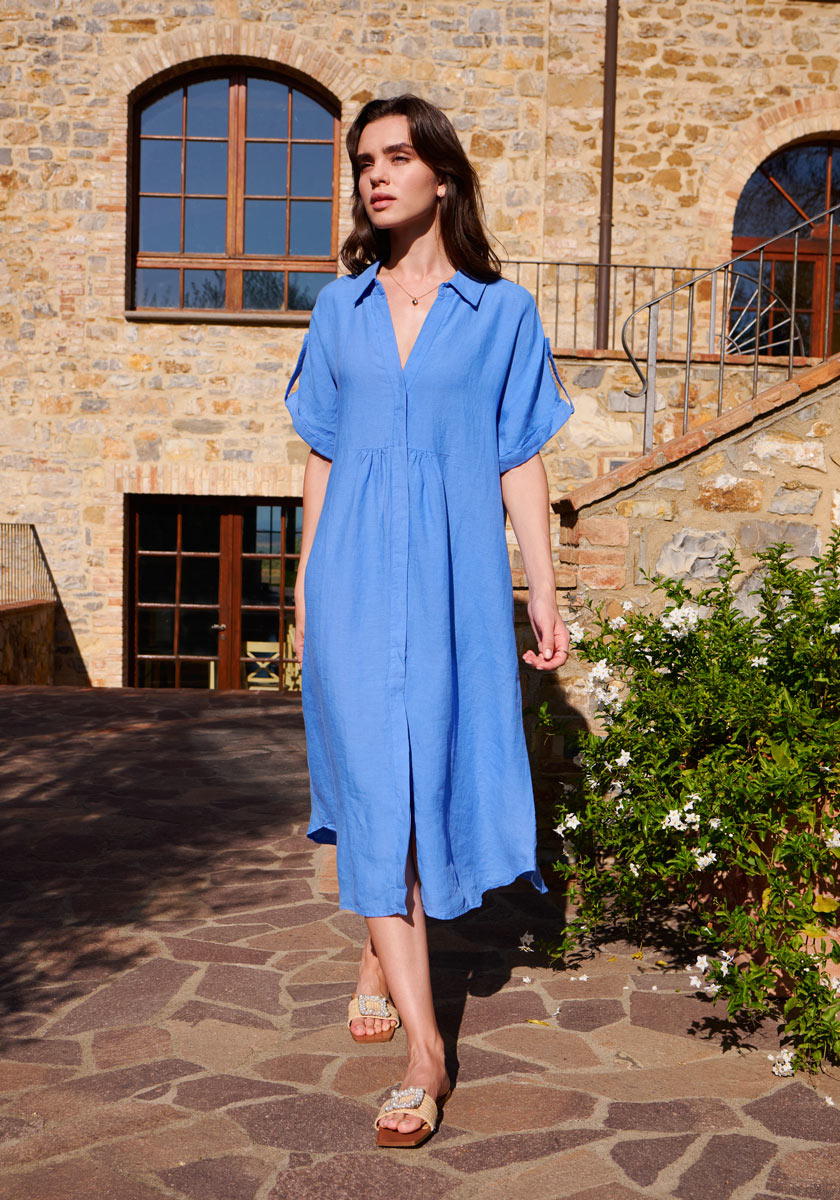 Linen shirt dress in blue worn by a lady in summer