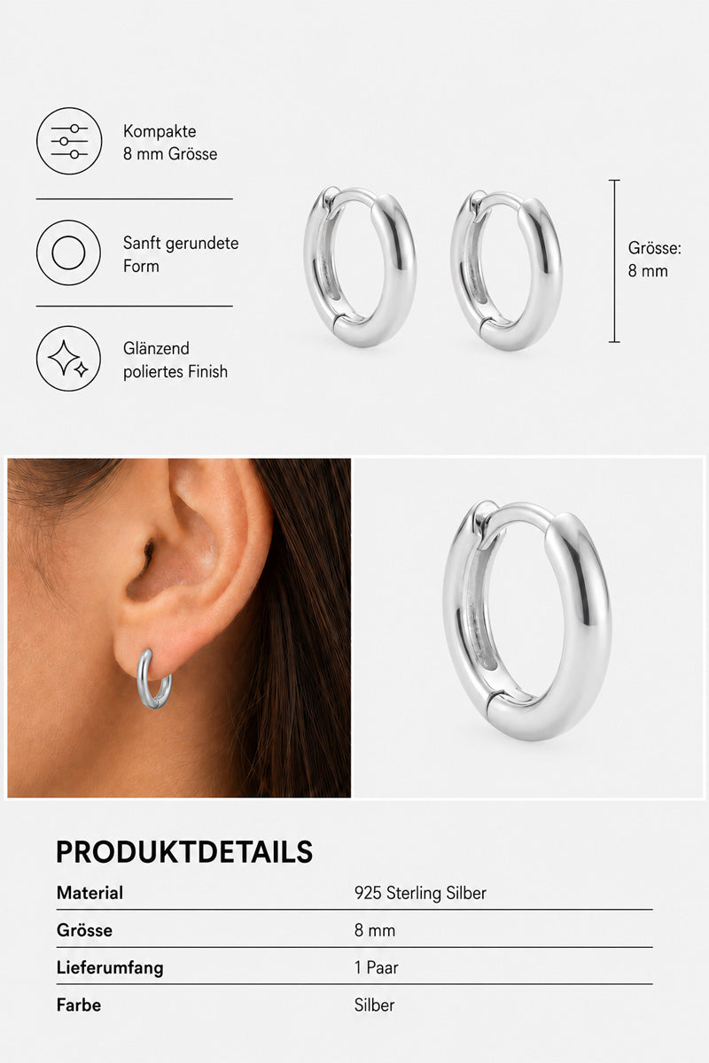 Zwei kleine, polierte 8-mm-Silber-Creolen von Princess Goes Hollywood aus 925er Sterlingsilber mit glatten, abgerundeten Kanten werden in Nahaufnahme gezeigt – eine davon am Ohr einer Person, um den perfekten „Ear-Stack“-Look zu demonstrieren. Zu den Details gehören eine Übersicht über die Symbole und Produktinformationen auf Deutsch.