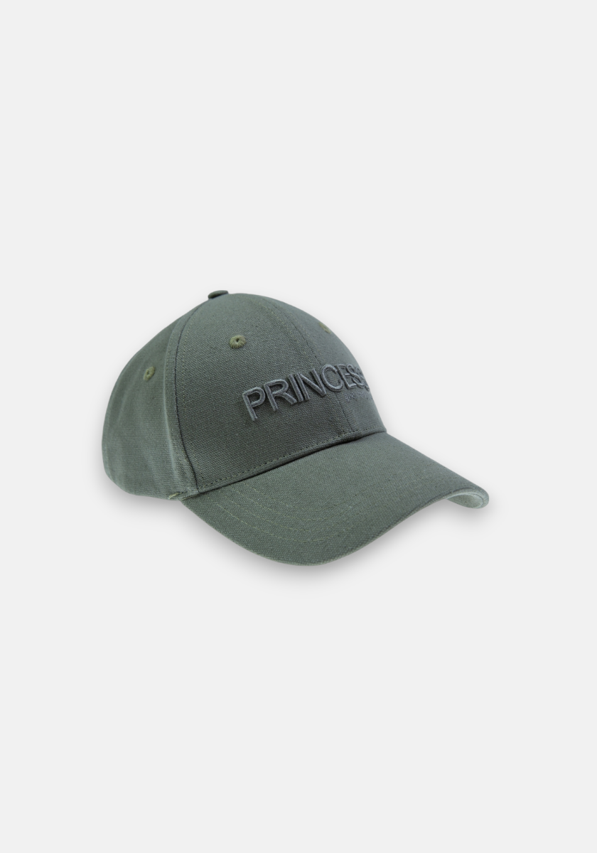 A dark green cotton baseball cap with a curved brim and stitched eyelets. PRINCESS is embroidered in matching green on the front, subtly referencing Princess Goes Hollywood. Shown against a light gray background.