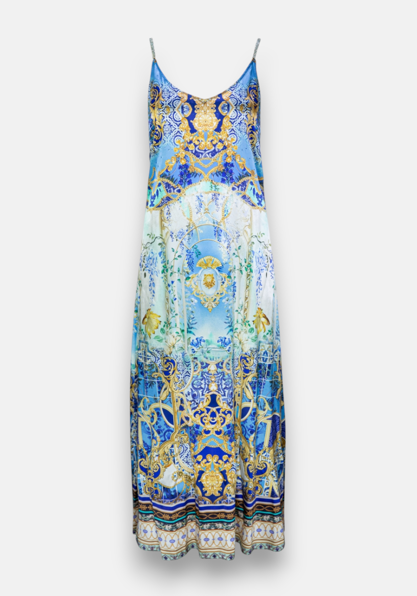 A sleeveless, floor-length Princess Goes Hollywood Trägerkleid with thin straps and an ornate blue, white, and gold baroque-inspired pattern featuring scrolls, filigree, seashells, fish motifs, and a central blue gradient for an oceanic luxury look.