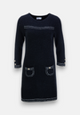 A knee-length black Strickkleid by Princess Goes Hollywood features three-quarter sleeves, white contrast stitching, two front pockets with gold-tone buttons, matching sleeve details, a straight silhouette, and a round neckline for a timeless look.