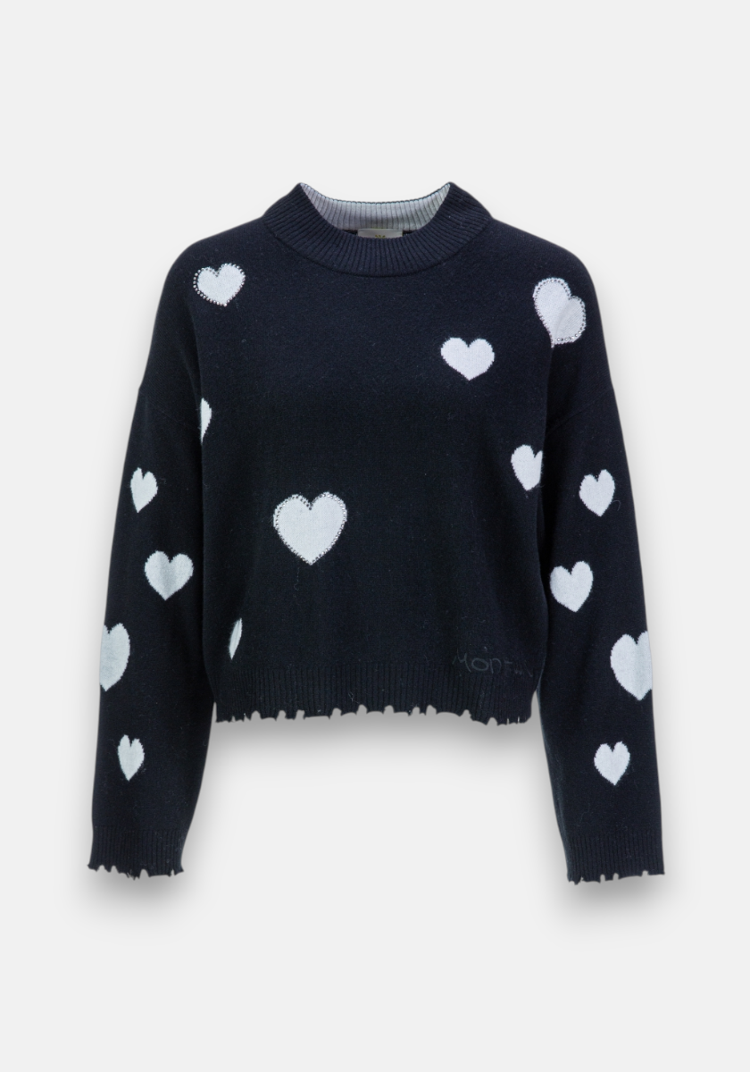 A black Feinstrickpullover by Princess Goes Hollywood in a wool-cashmere mix, loose fit, with ribbed collar and hem. Features white heart patterns of varying sizes on the front, sleeves, and shoulders.