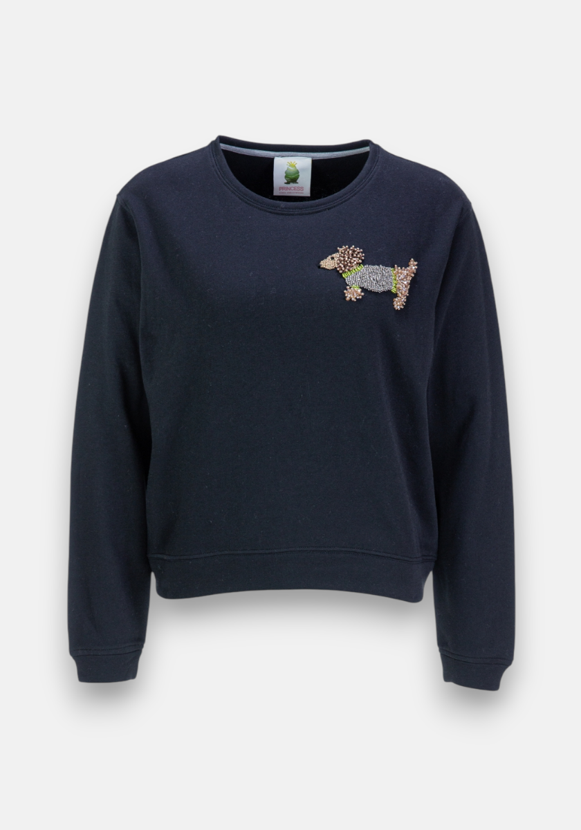 A navy blue crewneck sweatshirt by Princess Goes Hollywood with long sleeves, featuring an elegant Dackel-Motiv in brown, black, and gray bead embroidery on the left chest against a plain light gray background.