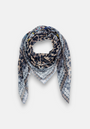 The Princess Goes Hollywood square scarf features pointed ends and a loose-loop style, showcasing Glam-Leo print, geometric patterns, and scattered text in neutral and blue on a light background. Made from semi-transparent, lightweight fabric.
