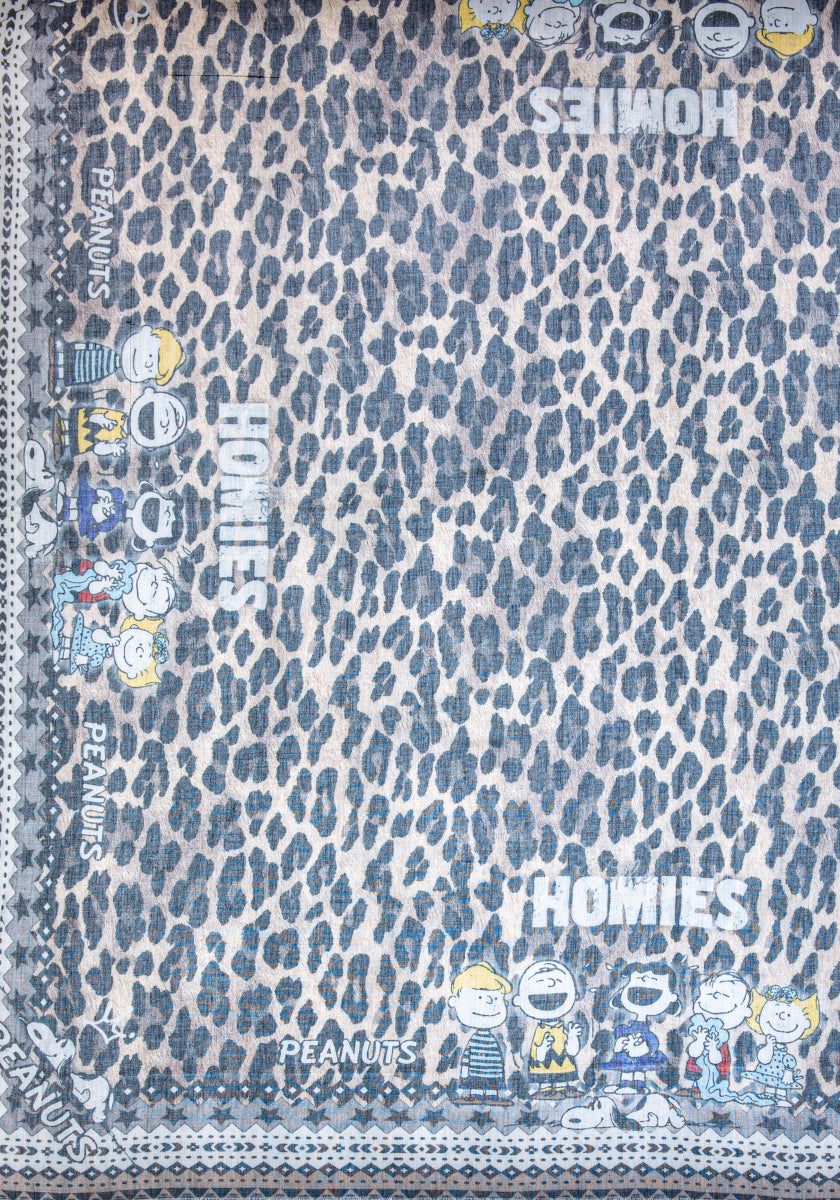 A blue and white Glam-Leo Print blanket by Princess Goes Hollywood features Peanuts characters with words like “HOMIES” and “PEANUTS” along the edges, creating a playful and cozy vibe.