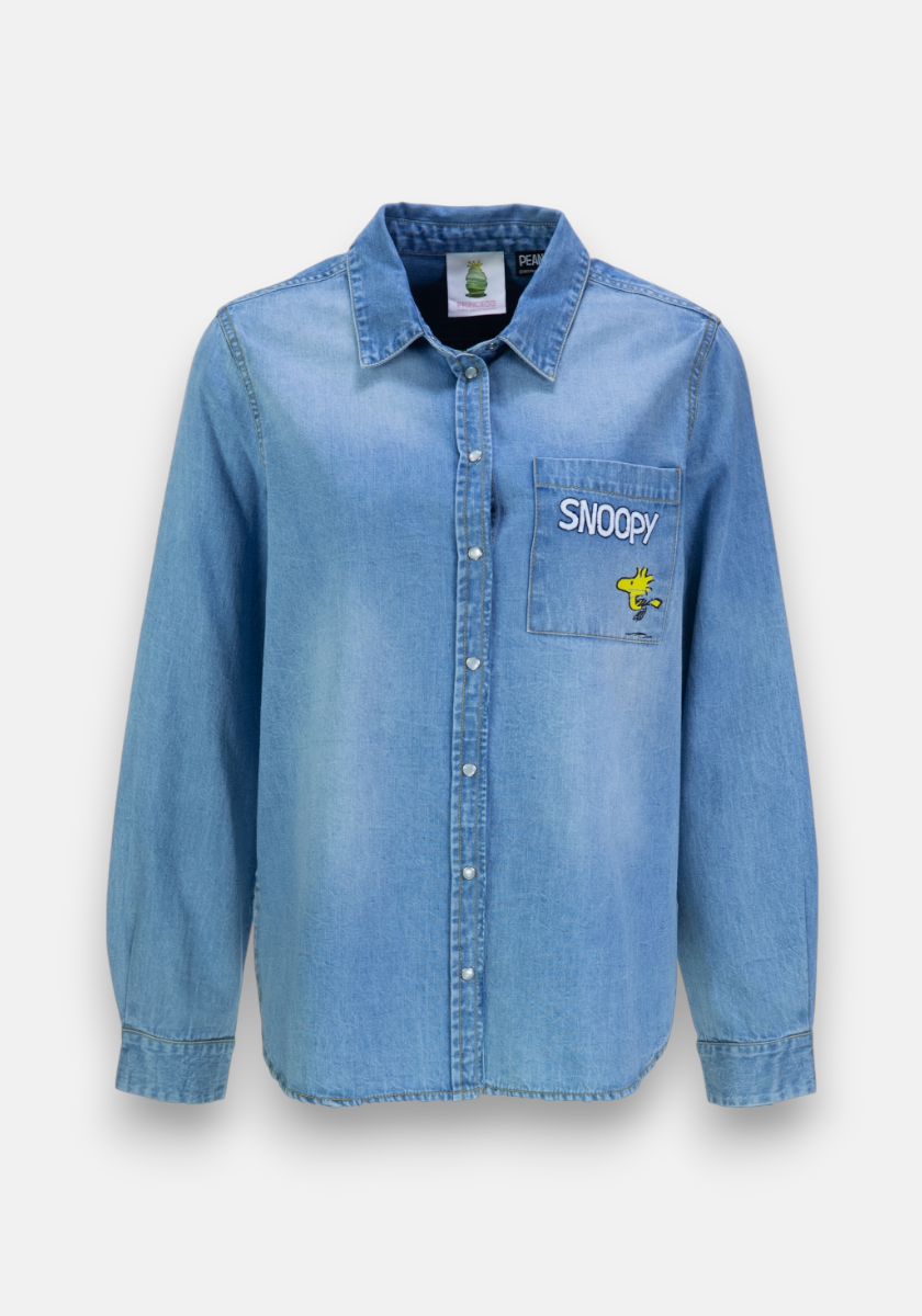 The Princess Goes Hollywood light blue cotton jeans shirt features a classic collar, long sleeves, and a single left chest pocket with Snoopy embroidery and an image of Woodstock from Peanuts.