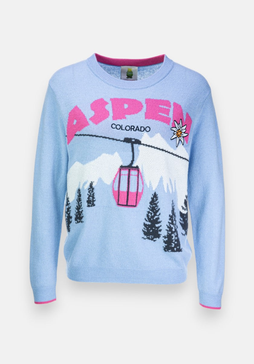 Hellblauer Princess Goes Hollywood Strickpullover mit pinkfarbenem und schwarzem ASPEN COLORADO Schriftzug, weißen Bergen, dunkelgrünen Tannen, einer rosa Skigondel, einer Edelweißblume und kuscheligen rosa Besätzen an Kragen, Ärmeln und Saum.