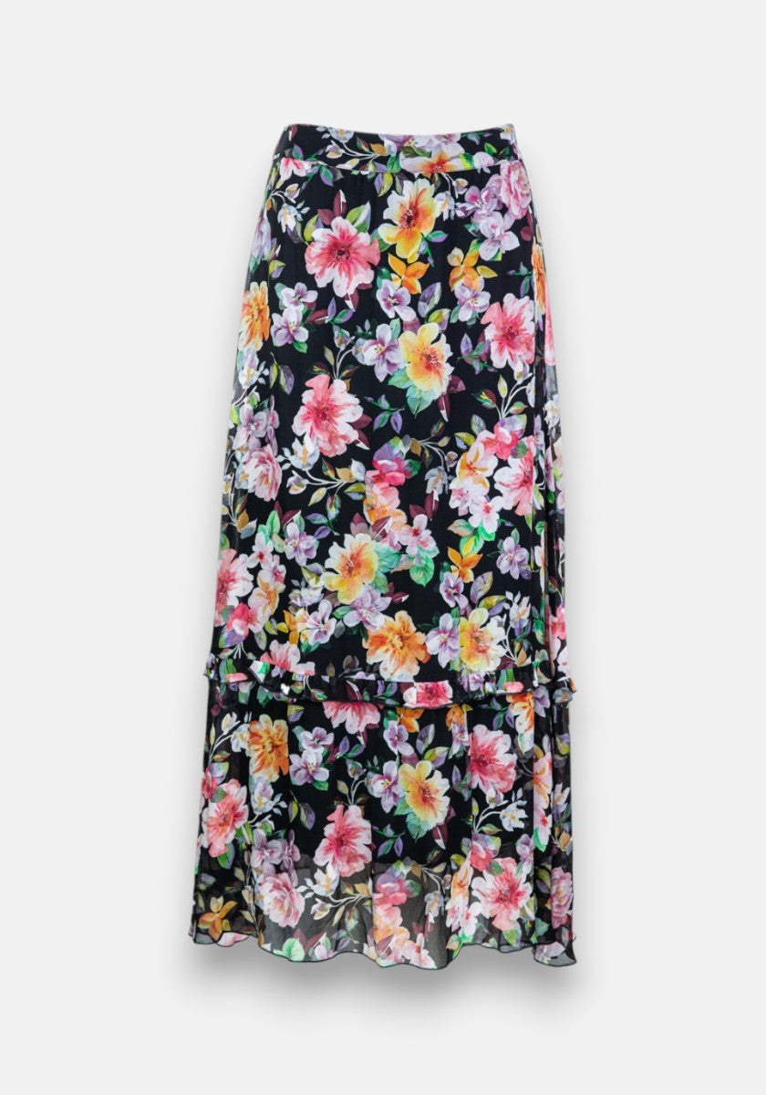 Der Princess Goes Hollywood Flower-Print Midirock hat einen schwarzen Grundton mit leuchtenden Blumen in Pink, Gelb, Orange und Lila, zarte Rüschendetails am Saum und eine mehrlagige, leicht asymmetrische Silhouette.