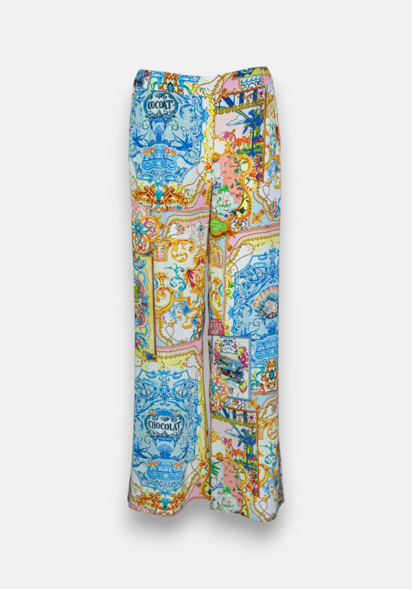 Hochtaillierte Hose mit weitem Bein von Princess Goes Hollywood aus 100 % Seide mit einem Dolce Vita-Druck in Blau, Orange, Gelb und Rosa. Verschnörkelte Rahmen, Vögel, Blumen und der Vintage-Schriftzug CHOCOLAT sorgen für einen lebendigen Barock-Look.