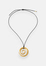 A gold spiral Edelstahl Anhänger with 18K Goldbeschichtung by Princess Goes Hollywood hangs from a simple, adjustable black cord Halskette with gold-tipped ends. The smooth, shiny pendant is set against a plain white background.