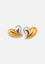 A pair of modern Princess Goes Hollywood Herz Ohrstecker; each earring contrasts shiny 18K gold stainless steel with polished silver, forming fluid, asymmetrical bicolor earrings set against a plain white background.